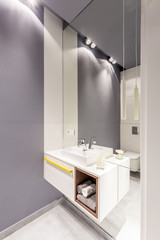Mirror in grey bathroom interior