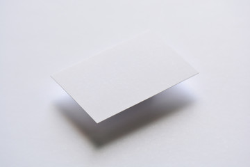 Photo of blank white business cards on white. Mock-up for branding identity. For graphic designers presentations and portfolios