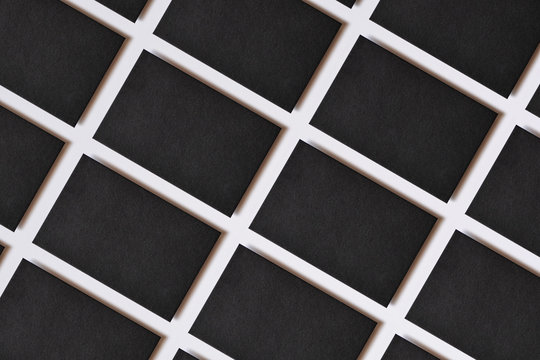 Photo of blank textured business cards on white. Mock-up for branding identity. For graphic designers presentations and portfolios. Business cards stacks arranged in rows at white paper background.