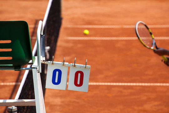 Tennis Player on a Clay Court with Umpire Chair
