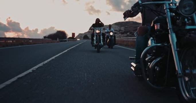 Group of rebel bikers riding on motorcycles on mountain road