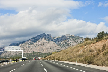 Naklejka premium Multi-lane highway in the distance of the mountain