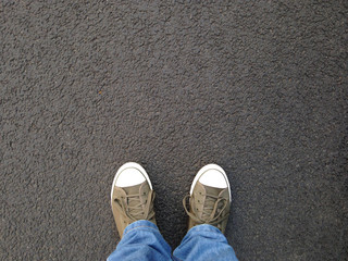 foot selfie or feet in canvas shoes standing on asphalt from personal perspective - Powered by Adobe