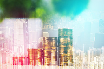 Double exposure of coin stack and little tree on city background with financial graph chart, business planning vision and finance analysis concept.
