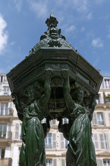 Fototapeta na wymiar green public fountain in Paris city