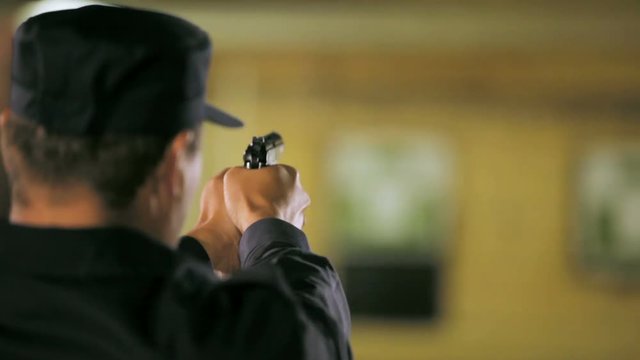 guard practises shooting with gun in range