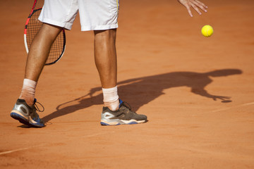 The tennis player puts the ball