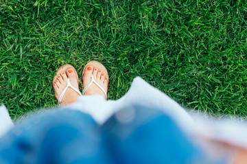 First person point of view of feet in sandals