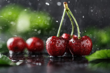 Fresh cherry with water drops on dark stone background. Fresh cherries background. Healthy food concept