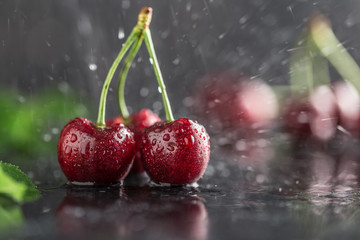 Fresh cherry with water drops on dark stone background. Fresh cherries background. Healthy food concept