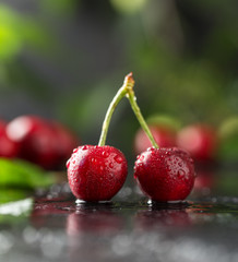 Fresh cherry with water drops on dark stone background. Fresh cherries background. Healthy food concept