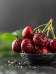 Fresh cherry with water drops on dark stone background. Fresh cherries background. Healthy food concept