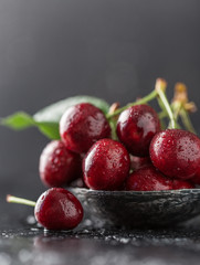 Fresh cherry with water drops on dark stone background. Fresh cherries background. Healthy food concept