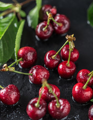 Fresh cherry with water drops on dark stone background. Fresh cherries background. Healthy food concept