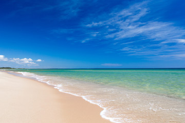 Fototapeta na wymiar Sea view from tropical beach with sunny sky. Summer paradise beach