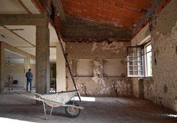Wheelbarrow in construction site, industrial under construction empty space, architectural ground work tools