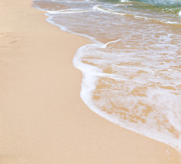 wave of blue ocean on sandy beach. Background.