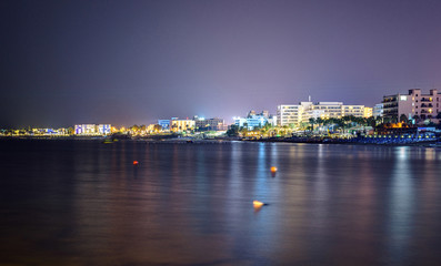 Fototapeta na wymiar Night cityscape with beachline
