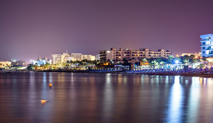 Fototapeta premium Night cityscape with beachline