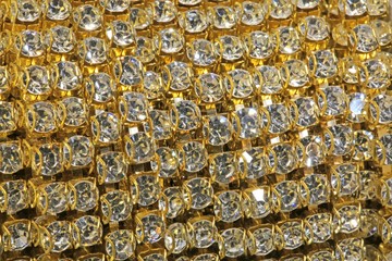 Detail of a roll of golden necklaces with precious stones set fo