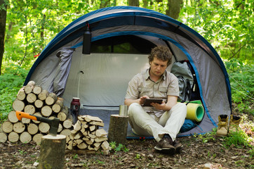 Traveller Uses A Tablet Outdoors.