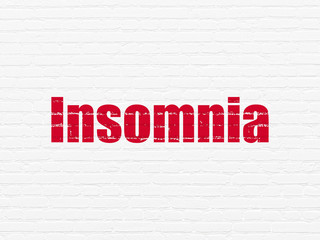 Health concept: Painted red text Insomnia on White Brick wall background