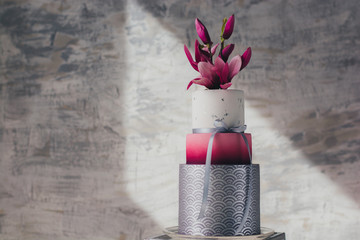 White wedding cake with flowers and blueberrie.Wedding details - wedding cake