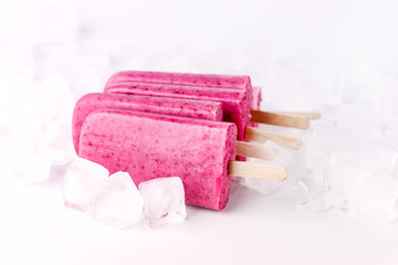 Obraz na płótnie Canvas Refreshing Homemade Berry Popsicle with Ice Cube Healthy Diet Summer Dessert White Background Tasty Ice Cream