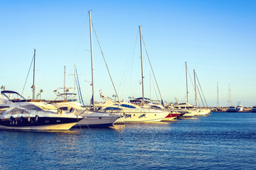 Sunset view to rich yachts parked in local port