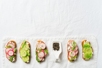 Some radish and cucumber toasts with ricotta and salad