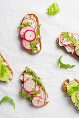 Some radish and cucumber toasts with ricotta and salad