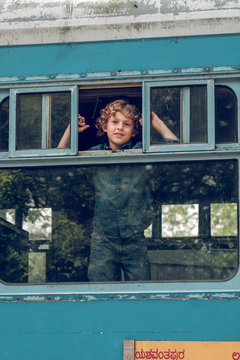 Playful child looking out of window