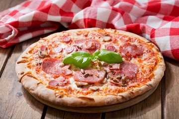 pizza with ham, salami and mushrooms
