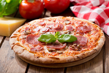 pizza with ham, salami and mushrooms