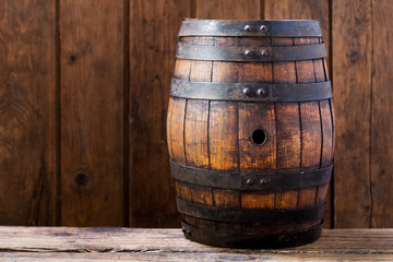 wooden barrel on rustic wooden background
