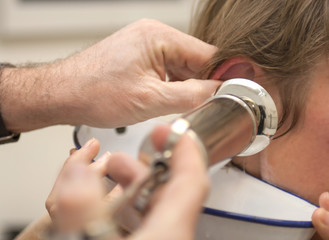 Cleaning ear with syringe