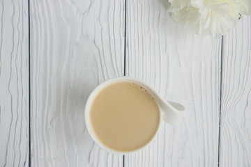 White cup of coffee on a white table  