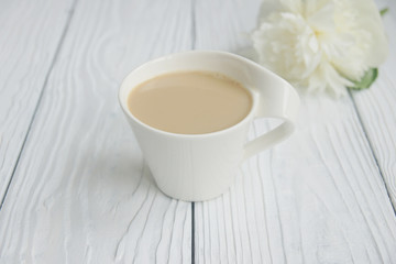 Fototapeta na wymiar White cup of coffee on a white table 