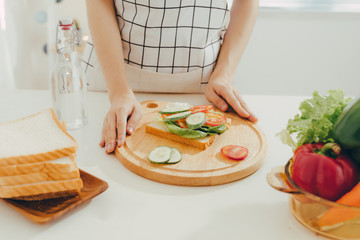 Woman apron preparing a breakfast in the kitchen