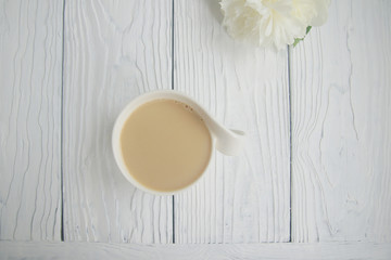 White cup of coffee on a white table  