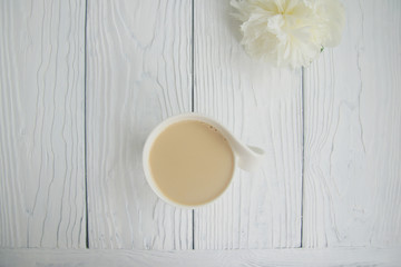 White cup of coffee on a white table  