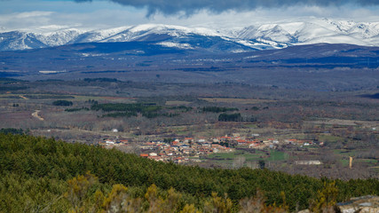 Fototapeta na wymiar Cional village with high snow covered mountains