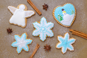 Fototapeta na wymiar homemade christmas cookie like snowflake and angel with cinnamon, anise with flour like snow top view