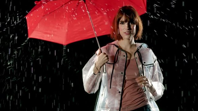 Beautiful woman dancing in the rain. Slow Motion.