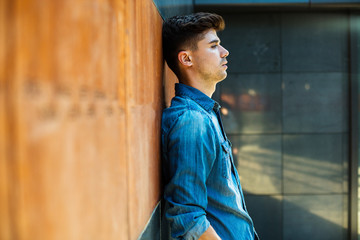 modern guy in jeans inside minimalist chamber