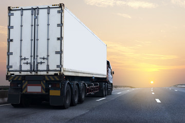 Truck on highway road with white container, transportation concept.,import,export logistic industrial Transporting Land transport on the asphalt expressway with sunrise sky