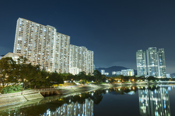 Fototapeta na wymiar high rise residential building and public estate in Hong Kong city at night