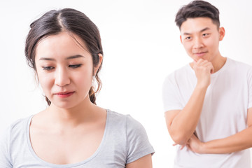 Couple in trouble. Young man looking at her girlfriend with a sly smile.