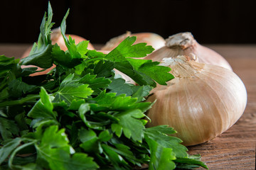 onions and parsley on a rustic table close-up