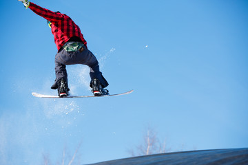Image of young sportive man jumping with snowboard